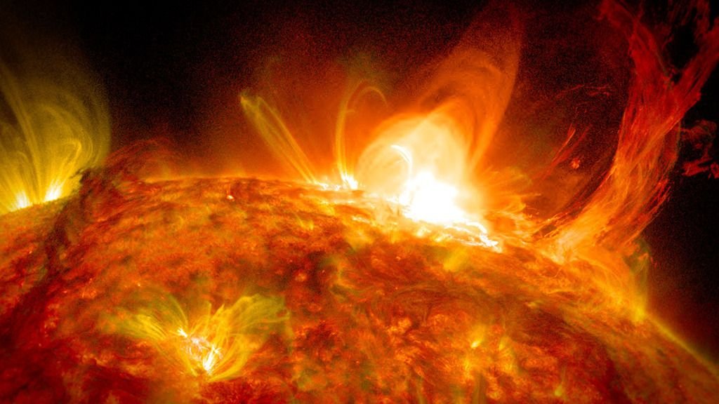 The sun releasing a burst of fiery plasma.